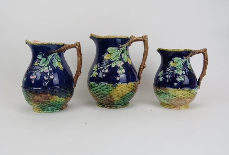 Set of three Majolica Blackberry pattern jugs in graduated sizes. Largest 8" height, smallest 6 1/4"