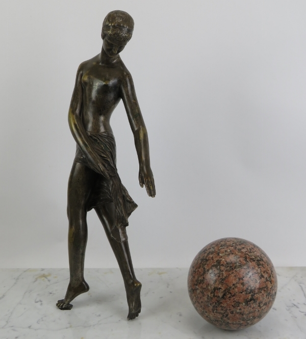A large Neoclassical bronze and marble sculpture of a Grecian female with ball. The figure cast in - Image 2 of 4