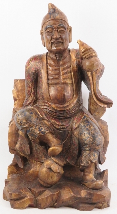 A Chinese gilt and lacquer painted carved wood figure of an immortal, 20th century. Depicted