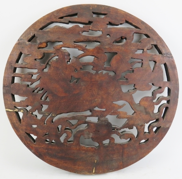 A large Chinese carved wood roundel, 20th century. Carved in openwork depicting a dragon amongst - Image 2 of 2