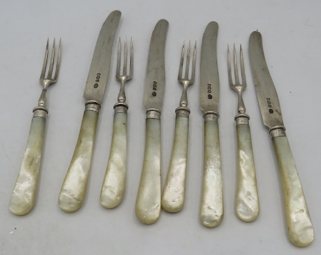 A set of four silver & mother of pearl fruit knives and forks, Sheffield 1925. Condition report: Age