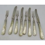 A set of four silver & mother of pearl fruit knives and forks, Sheffield 1925. Condition report: Age