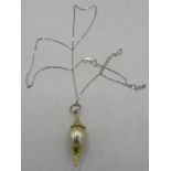 A bespoke Australian Golden Southsea pearl pendant set between planished yellow metal mounts. The