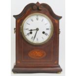 An Edwardian mahogany inlaid mantle clock. With a marquetry inlaid mahogany case, circular
