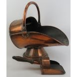 A copper coal scuttle and shovel, late 19th/early 20th century. (2 items) Coal Scuttle: 18 in (46