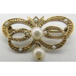 A 9ct yellow gold brooch in the form of a butterfly and set with centre pearl, pearl pendant and
