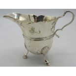 A silver cream jug with wavy edge decoration and hoof feet, London 1899. Approx weight 3.3 troy oz/
