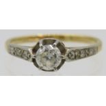 An 18ct yellow gold solitaire diamond ring with diamond shoulders. Centre diamond approx 0.25cts,