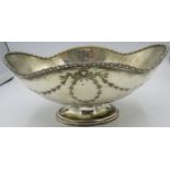 An oval shaped silver pedestal bowl engraved with swags & bows, Sheffield 1919. Approx 9"/23cm