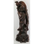 A Chinese carved wood figure of an immortal, 20th century. 37 in (94 cm) height. Condition report: