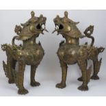 A large pair of Chinese bronze armoured dogs. (2 items) 22.8 in (58 cm) height. Condition report: