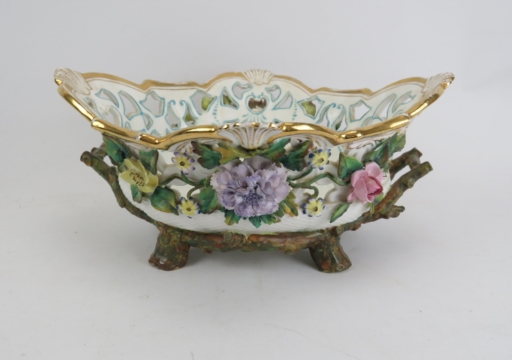 A European porcelain basket, late 19th/early 20th century. Applied with flowers, leaves and branches