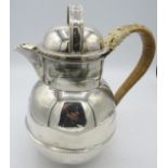 A large silver Guernsey jug with wicker handle, London 1948, engraved shield. Approx 8"/20cm high,