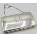 A silver rectangular purse on a chain, Birmingham 1912, monogrammed, with green silk liner. Approx