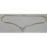 An 18ct yellow & white gold delicate necklace. The centre design having leaf decoration and set with