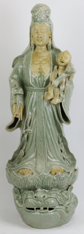 A large Chinese celadon glazed porcelain figure of Guanyin, 20th century. Depicted standing