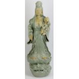 A large Chinese celadon glazed porcelain figure of Guanyin, 20th century. Depicted standing