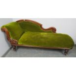 A Victorian mahogany show-wood chaise longue, with scrolled backrest and carved acanthus leaf