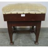 An Edwardian mahogany height-adjustable music stool, recovered in cream velvet material with brass