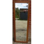 An Arts & Crafts satin walnut rectangular bevelled wall mirror, strung with ebony and parquetry