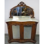 A Victorian walnut serpentine fronted chiffonier, the mirror back with foliate carved cornice and