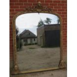 A large Victorian arched over-mantle mirror, the gilt gesso frame with shell cornice amidst