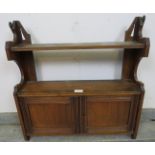 An Edwardian mahogany wall hanging shelf, with cupboard under. H60cm W59cm D16cm (approx). Condition