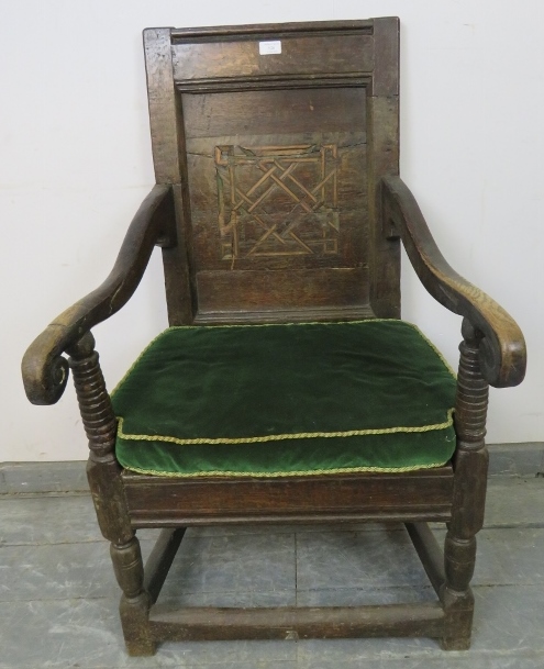 A 17th century oak Wainscot chair with walnut parquetry back panel, joined with scrolled arms to a