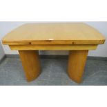 An Art Deco Period bird’s eye maple draw-leaf extending dining table, on curved supports. H77cm