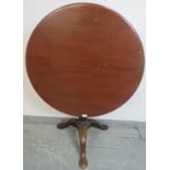 A 19th century mahogany circular tilt-top ‘birdcage’ table, on a plain tapering column and splayed