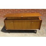 A mid-century teak ‘Librenza’ sideboard by G Plan, housing three short drawers above bi-folding