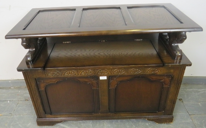 A vintage oak monk’s bench, with lion armrests, carved frieze and front panels, including loose