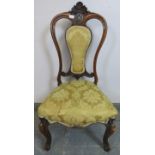 A Victorian walnut bedroom chair, with carved shell cornice above pierced fretwork roundel,