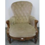 A Victorian walnut armchair upholstered in buttoned grey velvet material, on tapering supports.