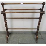 A Victorian mahogany double towel rail, with barley twist uprights, on scrolled supports. H85cm