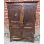 An 18th century pine bacon/pantry cupboard, the panelled doors opening onto hanging rails above