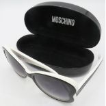 A pair of black reverse heart sunglasses with white edging, cased. Provenance: Part of a private