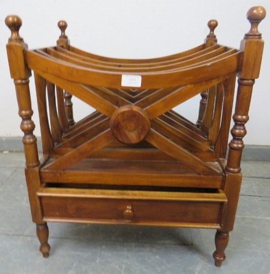 A hardwood Canterbury in the Regency taste, with ball finials above four divided magazine