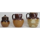 Three Royal Doulton salt glazed stoneware objects. Comprising two jugs and a jar with cover. (3