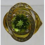 Peridot ring, faceted round cut solitaire of good colour and clarity, overall face of ring 18mm,