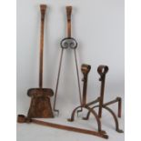 A set of Arts and Crafts fireplace implements, late 19th century. Comprising a pair of fire dogs,