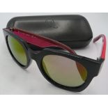 Alexander McQueen black sunglasses with pink and black arms, cased. Provenance: Part of a private