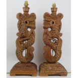 A pair of Oriental style carved wood dragon table lamps, 20th century. (2 items) 21.6 in (55 cm)
