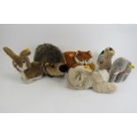 A group of Steiff stuffed toys. Comprising a fox, hedgehog, elephant, duck and two bunnies each with