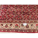 A fine mid 20th century Persian carpet central block pattern on red ground with flowered cream