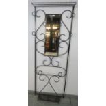 A vintage French wrought iron hall stand painted black, featuring scrolled detail and six coat-