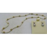 A strand of pearls with a 14ct gold ball clasp and matching spacers, boxed. Approx 16" long,