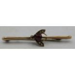 A 9ct yellow gold bar brooch of a winged insect set with centre garnet & each wing with two seed