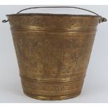 A rare Middle Eastern embossed brass swing handle bucket, 19th century. Probably Syrian, the central