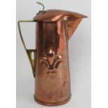 An Arts & Crafts copper and brass ewer, late 19th century. Modelled with a hinged cover, angular